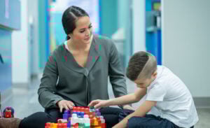 A support assistant helping a young person